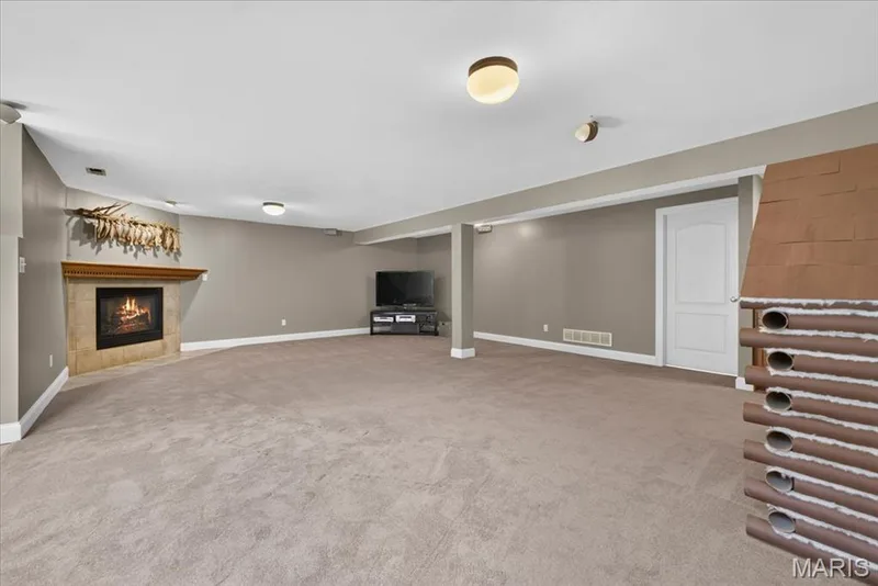 Finished lower level with rec area, fireplace, bedroom #3 and full bath — 2418 Golden Bear Way #711A, Wentzville, MO 63385