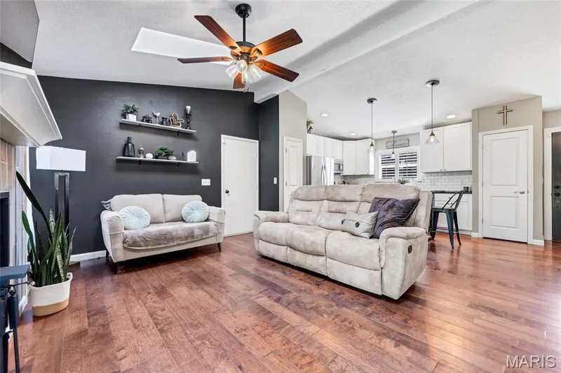 Warm wood floors anchor the main living space in effortless, natural comfort. — 601 Big Timber Lane, O'Fallon, MO 63368