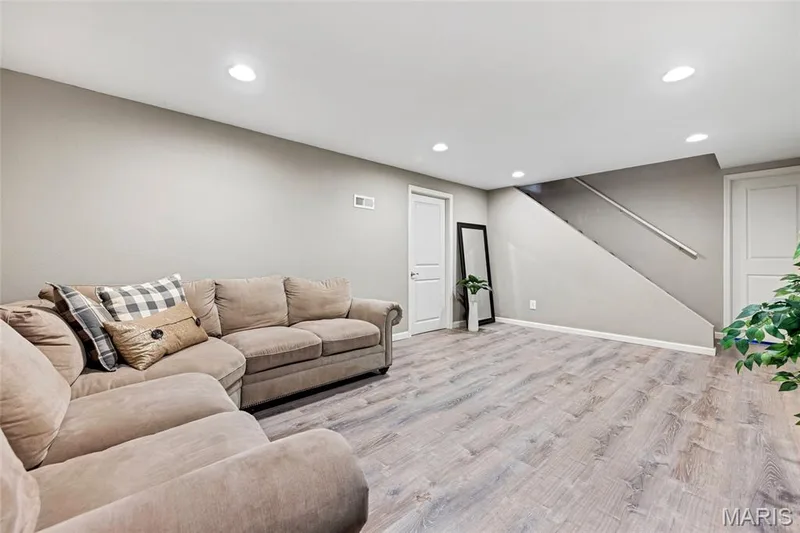 Clean, bright, and endlessly versatile. The light wood floors and recessed lighting keep every corner glowing, making this smart layout ready for game days, play time, or movie nights. — 601 Big Timber Lane, O'Fallon, MO 63368