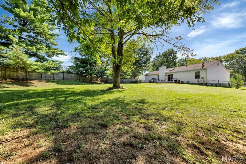 Imagine the possibilities: from firepit nights and family gatherings to soccer, golf, or the ultimate playground setup. Surrounded by privacy fencing and mature trees, this huge yard is your own private outdoor playground. — 601 Big Timber Lane, O'Fallon, MO 63368