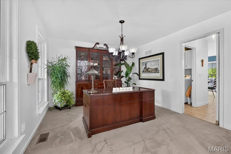 Neutral wall color, carpeted flooring, white trim, recessed windows, and an overhead chandelier — 5856 Canterfield Court, Weldon Spring, MO 63304
