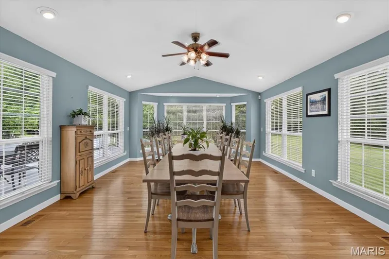 Hardwood flooring throughout, vaulted ceiling, recessed lighting, ceiling fan, and multiple windows with blinds — 5856 Canterfield Court, Weldon Spring, MO 63304