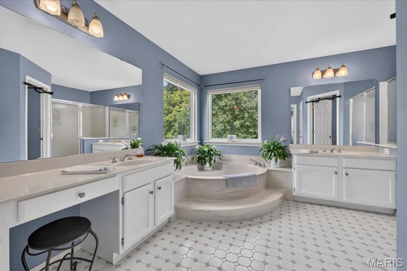 Dual vanity with under-sink cabinetry and a built-in makeup counter — 5856 Canterfield Court, Weldon Spring, MO 63304