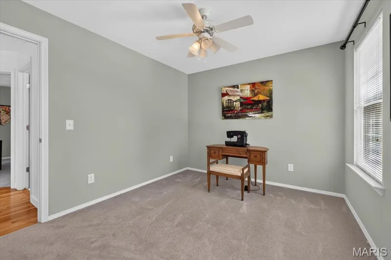 Light-colored carpeting, ceiling fan with integrated lighting, window with blinds, and white trim — 5856 Canterfield Court, Weldon Spring, MO 63304