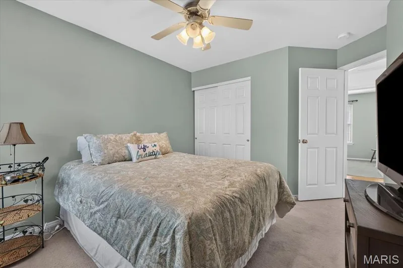 Recessed ceiling light, ceiling fan with light fixture, carpeted flooring, bi-fold closet doors, and a six-panel door — 5856 Canterfield Court, Weldon Spring, MO 63304