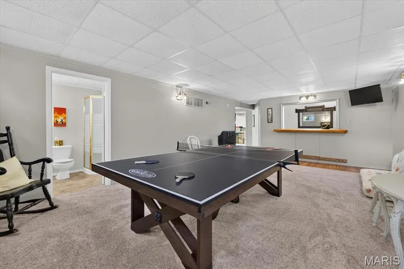 Finished basement with recessed lighting, integrated bar area, and a separate room with a shower enclosure — 5856 Canterfield Court, Weldon Spring, MO 63304