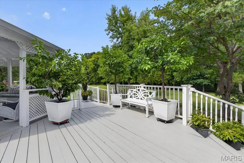 Expansive deck with white railings, a built-in lattice panel, and a covered gazebo area — 5856 Canterfield Court, Weldon Spring, MO 63304