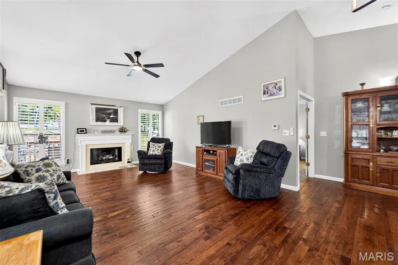 Large great room with hardwood flooring and gas fireplace — 2417 S Lakeridge Court #14, Lake St. Louis, MO 63367