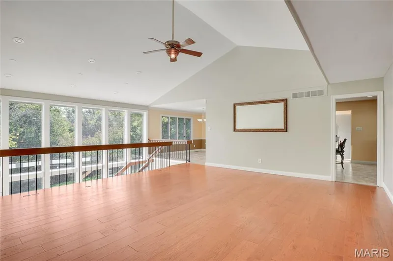 Vaulted ceiling with a ceiling fan, recessed lighting, wood-finish flooring, and a window wall — 2508 Peppermill Lake Court, Chesterfield, MO 63005