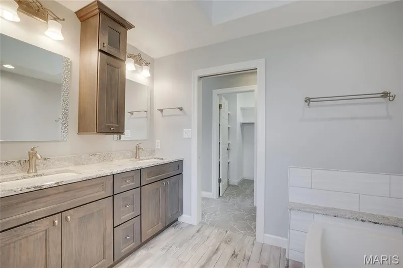 Dual vanity with undermount sinks, light-toned countertops, and wood-finish cabinetry — 2508 Peppermill Lake Court, Chesterfield, MO 63005