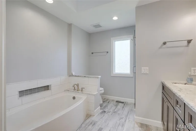 Fabulous primary suite bathroom with luxury bath and remote-control skylight — 2508 Peppermill Lake Court, Chesterfield, MO 63005