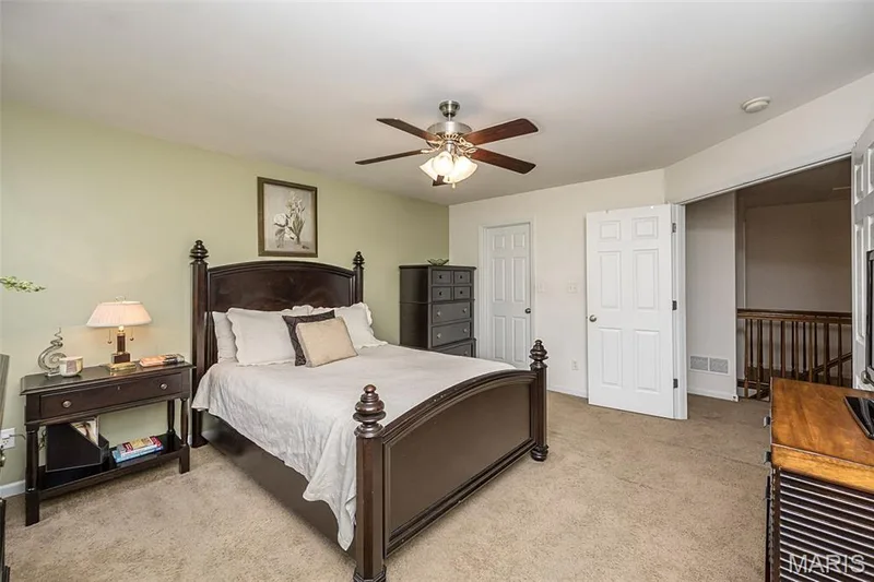 Primary bedroom featuring French doors — 500 Flowering Magnolia Drive, O'Fallon, MO 63366
