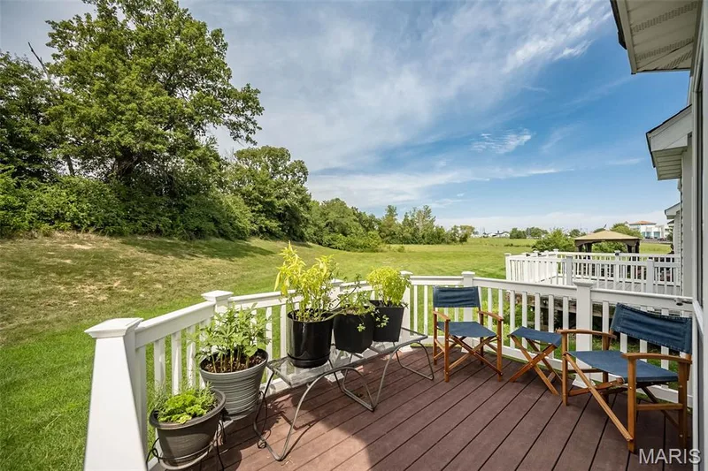 Expansive rear deck featuring composite decking and white railing — 500 Flowering Magnolia Drive, O'Fallon, MO 63366