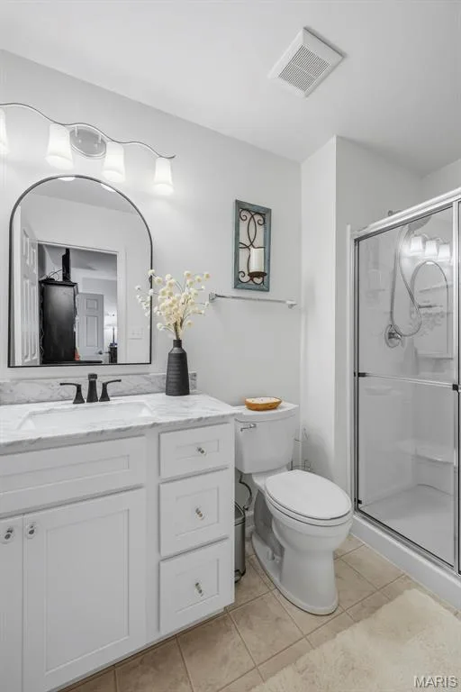 Updated  primary bath with solid surface countertop, framed mirror & fixtures! — 3404 Reed Crossing Street, St Charles, MO 63301