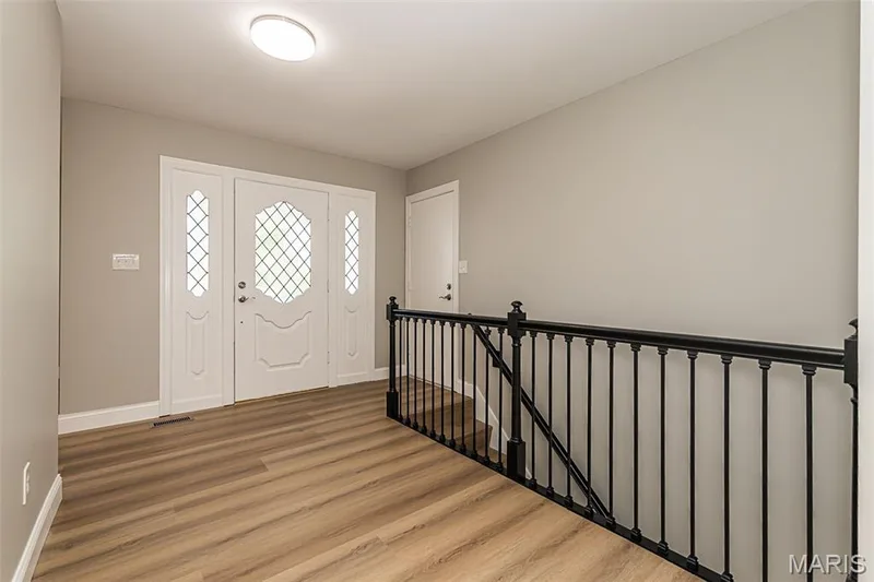 Garage entrance into the foyer and stairs down to LL — 2477 Baxton Way, Chesterfield, MO 63017
