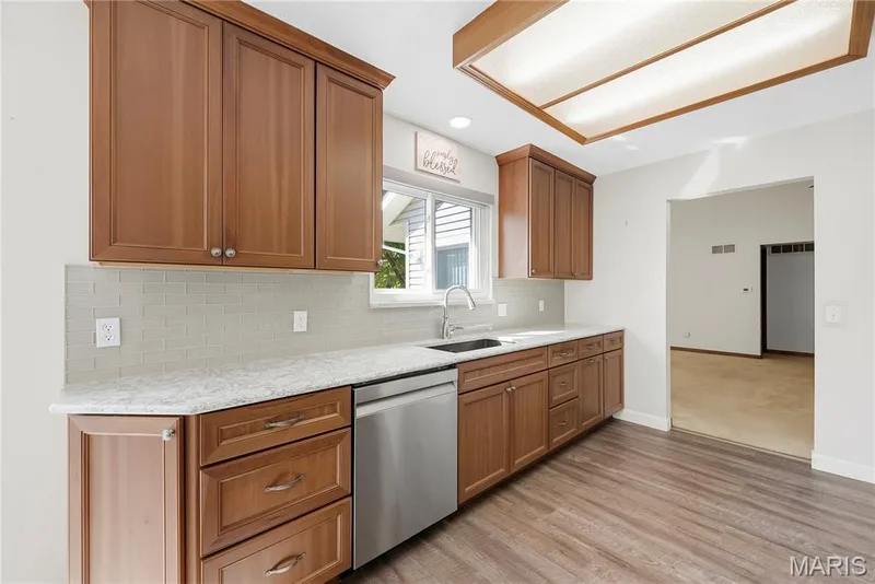 Quartz Countertops, Tile Backsplash and Stainless Steel Appliances in Kitchen — 3044 Brentmoor Drive, St Charles, MO 63303