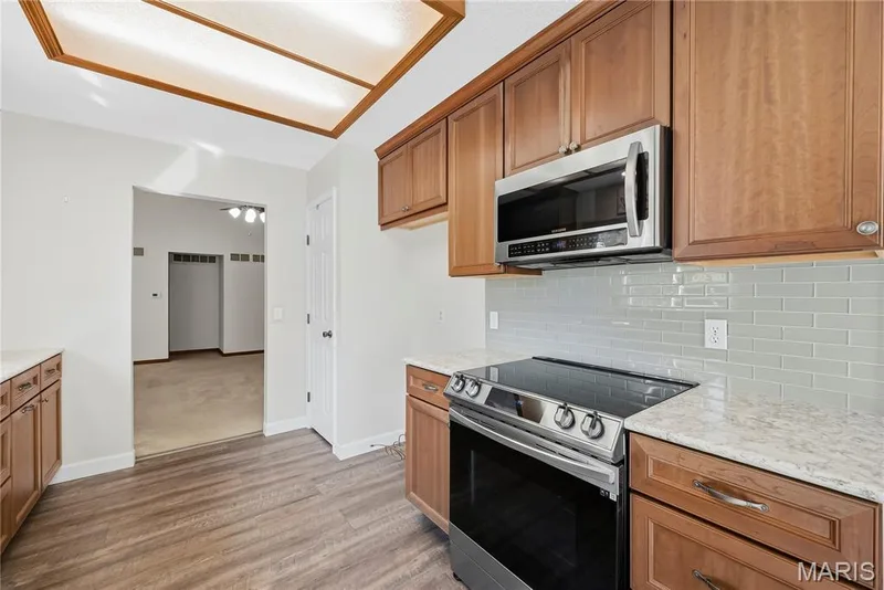 Updated Kitchen with Smooth Top Electric Range, Stainless Steel Appliances, Quartz Countertops and Tile Backsplash — 3044 Brentmoor Drive, St Charles, MO 63303
