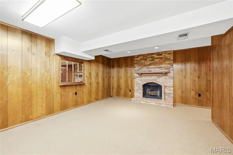 Family Room with Wood Burning Fireplace in Finished Lower Level — 3044 Brentmoor Drive, St Charles, MO 63303