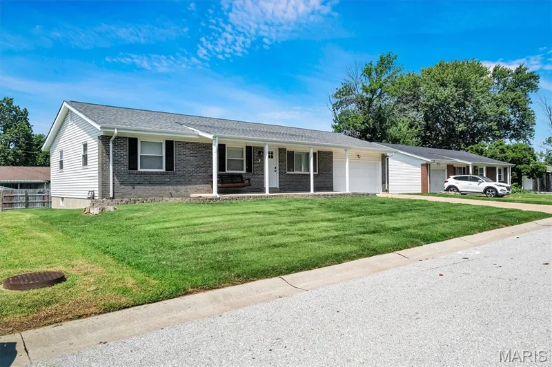 Ranch-style exterior with a dark brick facade, white siding, and a covered porch — 7 Saint Mark Drive, St Peters, MO 63376