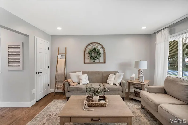 Recessed ceiling lighting illuminates the interior, featuring light-toned wall paint and wood-finish flooring — 7 Saint Mark Drive, St Peters, MO 63376