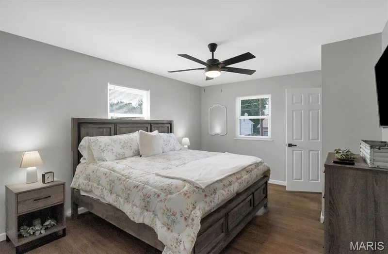 Wood-finish flooring with light gray walls, white trim, and a ceiling fan with integrated lighting — 7 Saint Mark Drive, St Peters, MO 63376