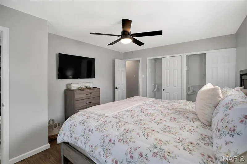 Wood-finish flooring, ceiling fan, and white paneled doors — 7 Saint Mark Drive, St Peters, MO 63376