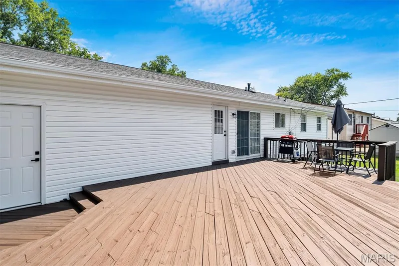 Expansive wood deck with a dark railing and integrated steps — 7 Saint Mark Drive, St Peters, MO 63376