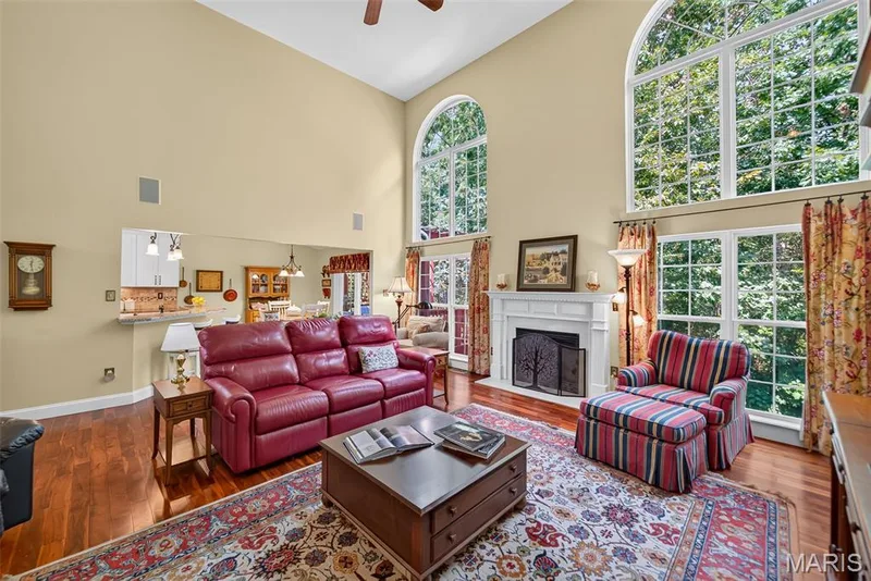 Cozy gas log fireplace flanked by floor to ceiling windows — 730 Longfellow Circle, O'Fallon, MO 63366