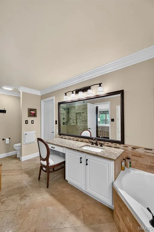 Dual sinks and seated vanity area with large walk-in closet — 730 Longfellow Circle, O'Fallon, MO 63366