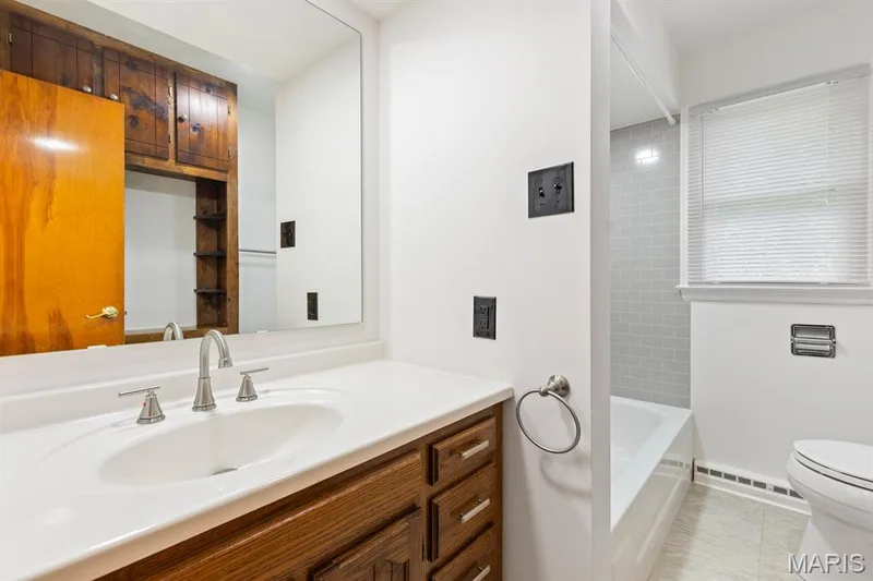 Main level bath with new vanity top and tub surround — 14 Connie Drive, St Charles, MO 63301