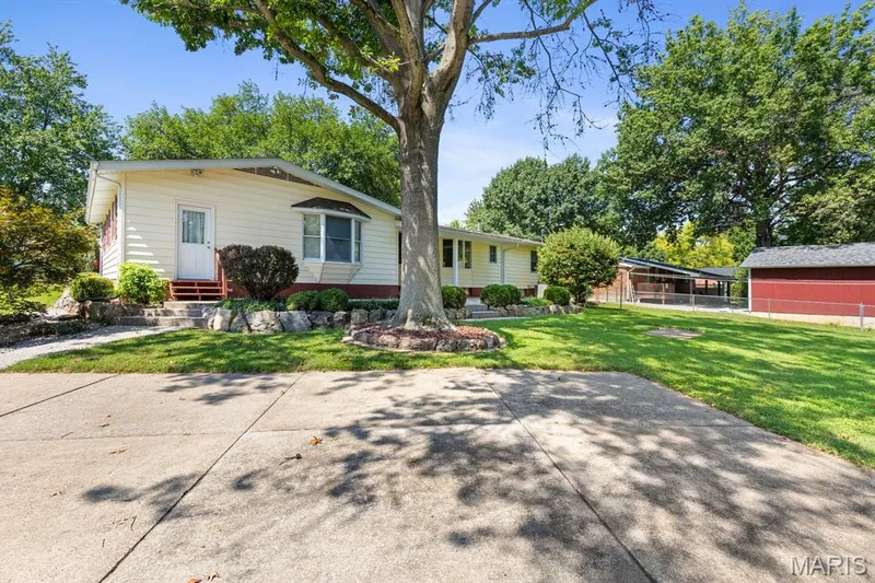 Rear view of home featuring an extra driveway with electric-perfect for RV parking — 14 Connie Drive, St Charles, MO 63301