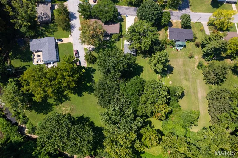 Arial view of property showing a partial view of additional lot & creek — 14 Connie Drive, St Charles, MO 63301