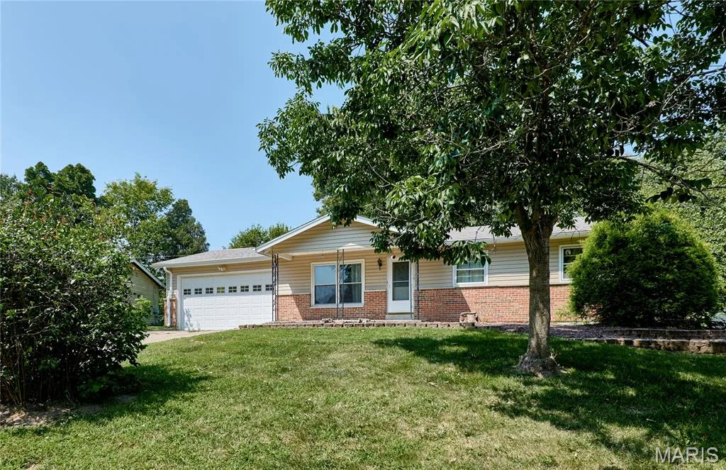 Ranch-style exterior with brick detailing and horizontal siding — 318 Capri Drive, O'Fallon, MO 63366