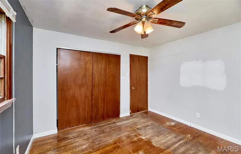 Wood-finish flooring with a ceiling fan light fixture — 318 Capri Drive, O'Fallon, MO 63366