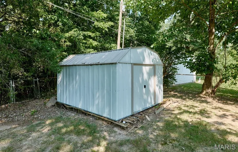 Metal storage shed with a gabled roof — 318 Capri Drive, O'Fallon, MO 63366