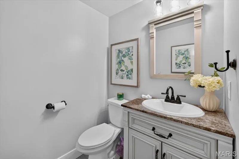 Vanity with built-in cabinetry, oval sink, and bronze-finish faucet — 35 Snowmass Court, O'Fallon, MO 63368
