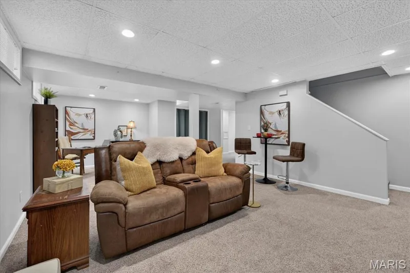Carpeted flooring throughout, recessed lighting, drop ceiling, light gray wall color, and a built-in staircase — 35 Snowmass Court, O'Fallon, MO 63368