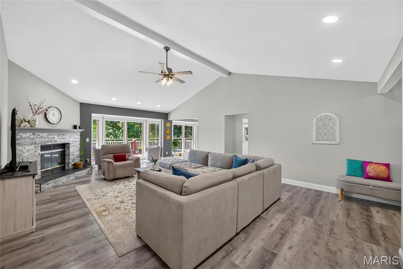 Living room with vaulted ceiling, ceiling fan and recessed lighting — 6 Potomac Court, St Charles, MO 63303