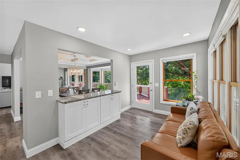 Sitting room with granite counter leading into the dining room — 6 Potomac Court, St Charles, MO 63303