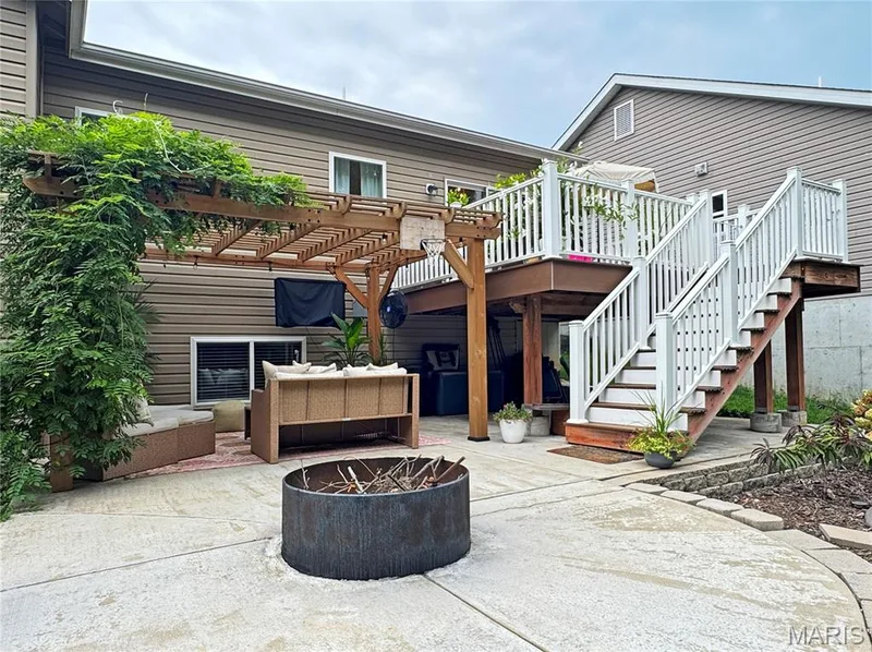 Lower-level patio with a pergola, concrete hardscaping, and a round fire pit — 4024 Glengarry Drive, Wentzville, MO 63385