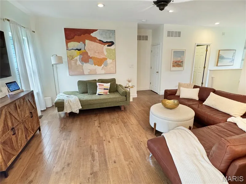Wood-finish flooring throughout, recessed ceiling lighting, ceiling fan, and white interior doors — 4024 Glengarry Drive, Wentzville, MO 63385