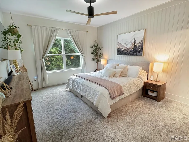 Carpeted flooring, window with natural light, ceiling fan, and paneled wall — 4024 Glengarry Drive, Wentzville, MO 63385
