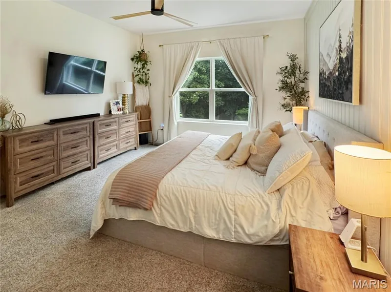 Carpeted flooring, window with natural light, ceiling fan, and wall paneling — 4024 Glengarry Drive, Wentzville, MO 63385