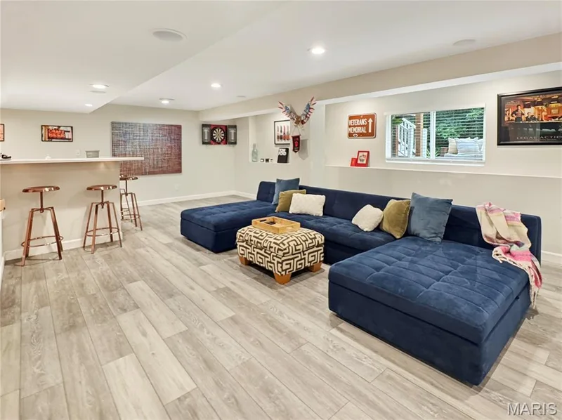 Recessed ceiling lighting, LVP flooring, built-in bar, and a window with natural light — 4024 Glengarry Drive, Wentzville, MO 63385