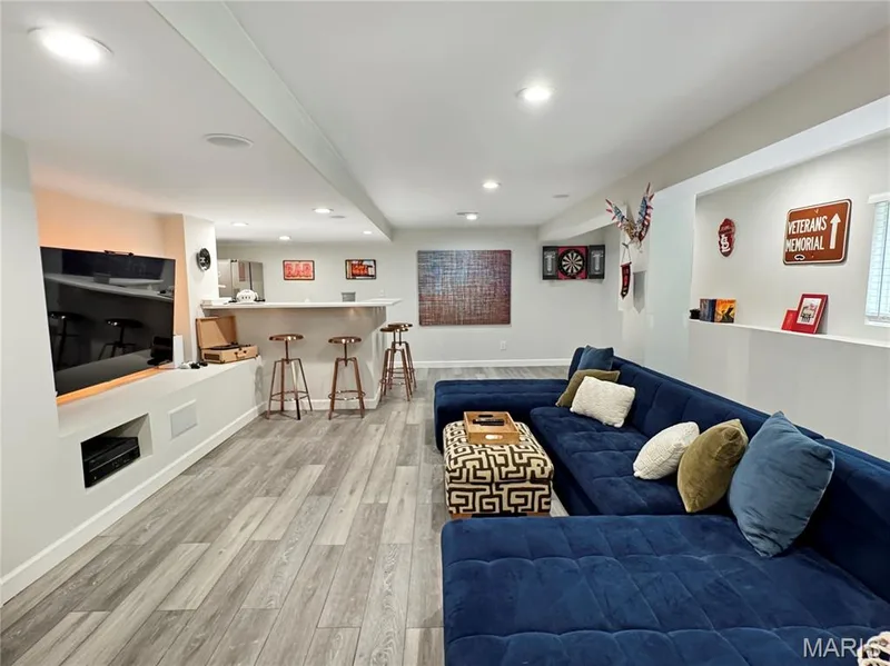 Recessed lighting throughout, LVP flooring, built-in entertainment niche, and a dedicated wet bar with integrated appliances — 4024 Glengarry Drive, Wentzville, MO 63385