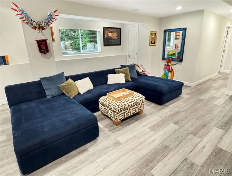 Recessed lighting, light gray LVP flooring, white trim, and a window with blinds — 4024 Glengarry Drive, Wentzville, MO 63385
