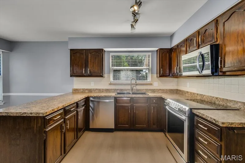 Counterspace galore and large breakfast bar. Window over kitchen sink brings in lots of light. — 1346 Cherry Glen Court, Chesterfield, MO 63017