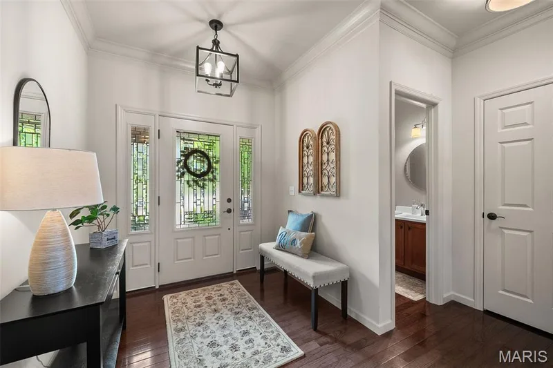 Entryway featuring a white paneled door with decorative glass, side lites, and a transom window — 2700 Grover Crossing Drive, Wildwood, MO 63040