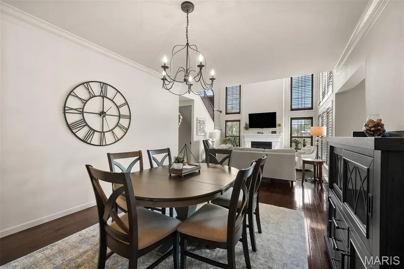 Hardwood flooring, crown molding, white walls, and a multi-level ceiling create a refined interior — 2700 Grover Crossing Drive, Wildwood, MO 63040