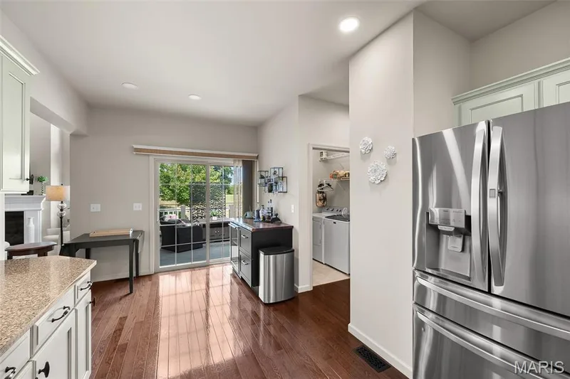 Hardwood flooring, sliding glass door, recessed lighting, and a stainless steel refrigerator — 2700 Grover Crossing Drive, Wildwood, MO 63040